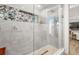 Luxurious walk-in shower with unique mosaic tile and elegant glass enclosure at 13612 87Th Ave, Seminole, FL 33776