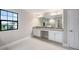 Bright bathroom featuring double sink vanity with granite countertop and large mirror at 14403 Woodland Spur Dr, Lithia, FL 33547
