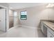 Bright bathroom featuring granite countertop, glass enclosed shower, and ceramic tiled floors at 14403 Woodland Spur Dr, Lithia, FL 33547