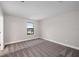 Bright bedroom featuring a single window and plush neutral-toned carpeting at 14403 Woodland Spur Dr, Lithia, FL 33547