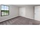 Comfortable bedroom with soft carpet, a large window with natural light, and closet with doors at 14403 Woodland Spur Dr, Lithia, FL 33547
