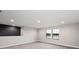 Upstairs bonus room with accent wall and large windows overlooking community at 14403 Woodland Spur Dr, Lithia, FL 33547