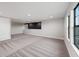 Spacious room featuring modern carpet and abundant natural light from the windows at 14403 Woodland Spur Dr, Lithia, FL 33547