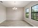 Bright dining room with decorative chandelier and large windows at 14403 Woodland Spur Dr, Lithia, FL 33547