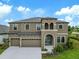 Stunning two-story home boasts an attached three-car garage and lush landscaping at 14403 Woodland Spur Dr, Lithia, FL 33547