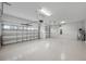 Clean, expansive garage with epoxy flooring and ample space for multiple vehicles at 14403 Woodland Spur Dr, Lithia, FL 33547