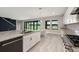 Spacious kitchen with stainless steel appliances, granite countertops, and views of the back yard at 14403 Woodland Spur Dr, Lithia, FL 33547