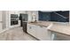 Modern kitchen showcasing a granite island, stainless steel appliances, and sleek white cabinetry at 14403 Woodland Spur Dr, Lithia, FL 33547