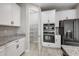 Stylish kitchen featuring white cabinets, granite counters, and state-of-the-art appliances at 14403 Woodland Spur Dr, Lithia, FL 33547