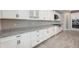 Modern kitchen featuring white cabinets, granite countertops, and stainless steel appliances at 14403 Woodland Spur Dr, Lithia, FL 33547