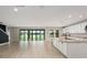 Open-concept living area featuring tile floors, large glass doors, and abundant natural light at 14403 Woodland Spur Dr, Lithia, FL 33547