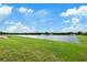 Scenic view of the beautiful pond that borders the home's backyard at 14403 Woodland Spur Dr, Lithia, FL 33547