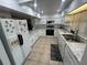 Bright kitchen featuring white cabinetry, tile backsplash, and modern appliances at 14633 Sassandra Dr, Odessa, FL 33556