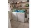 Practical laundry room with washer, dryer, and ample storage shelving at 14633 Sassandra Dr, Odessa, FL 33556