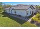 A side aerial view of a single-story home with a tile roof and manicured landscaping at 16710 Shell Bay Dr, Land O Lakes, FL 34638