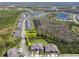 Aerial view of new home community featuring multiple ponds and lots of trees at 16710 Shell Bay Dr, Land O Lakes, FL 34638
