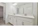 Bathroom featuring double sinks, vanity with drawers, and large mirror at 16710 Shell Bay Dr, Land O Lakes, FL 34638