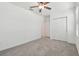 Clean bedroom featuring neutral carpet and ceiling fan with sliding-door closet at 16710 Shell Bay Dr, Land O Lakes, FL 34638