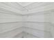 Walk-in closet with white wire shelving for optimal storage solutions at 16710 Shell Bay Dr, Land O Lakes, FL 34638