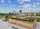 A beautiful community garden with raised beds and white pergola offers residents fresh produce and a tranquil outdoor space at 16710 Shell Bay Dr, Land O Lakes, FL 34638