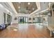 Well-lit fitness center with wood flooring, mirrors, and a unique wood panel ceiling at 16710 Shell Bay Dr, Land O Lakes, FL 34638