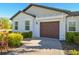 Home featuring a brown garage door with a brick driveway and well-maintained landscaping at 16710 Shell Bay Dr, Land O Lakes, FL 34638