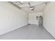 An attached one-car garage with painted floor and water heater at 16710 Shell Bay Dr, Land O Lakes, FL 34638