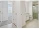Hallway view to bedroom with bath on tile flooring and white walls at 16710 Shell Bay Dr, Land O Lakes, FL 34638