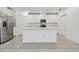 Bright kitchen with an island, stainless steel appliances, and white cabinetry at 16710 Shell Bay Dr, Land O Lakes, FL 34638