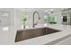 Close-up of a modern kitchen sink with stainless steel faucet and white quartz countertop at 16710 Shell Bay Dr, Land O Lakes, FL 34638