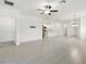Bright, open living space featuring tile floors with a view into the modern kitchen at 16710 Shell Bay Dr, Land O Lakes, FL 34638