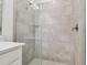 Elegant shower with glass door and tiled walls, adjacent to modern vanity at 16710 Shell Bay Dr, Land O Lakes, FL 34638
