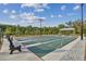 A view of the community shuffleboard courts with benches, lighting, and a shelter at 16710 Shell Bay Dr, Land O Lakes, FL 34638