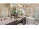 Beautiful bathroom with dual sinks, marble countertops, soaking tub, and glass shower at 1714 Trailhead Ln, Zephyrhills, FL 33541