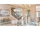Dining area showcasing elegant furnishings, a staircase, decorative lighting, and hardwood floors at 1714 Trailhead Ln, Zephyrhills, FL 33541
