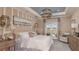 Well-lit primary bedroom featuring plush furniture, decorative lighting, and elegant decor and patio access at 1714 Trailhead Ln, Zephyrhills, FL 33541