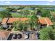 Aerial view showcasing the condo community, lush greenery, and water features at 1901 Oyster Catcher Ln # 823, Clearwater, FL 33762