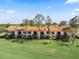 Backyard view of the condo complex with screened patios and lush lawn at 1901 Oyster Catcher Ln # 823, Clearwater, FL 33762