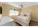 Inviting bedroom with a queen-size bed, ceiling fan, and lots of natural light at 1901 Oyster Catcher Ln # 823, Clearwater, FL 33762