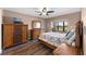Comfortable bedroom with dark wood furniture, ceiling fan, and a window overlooking the beautiful outdoors at 1901 Oyster Catcher Ln # 823, Clearwater, FL 33762