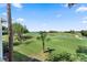 Scenic golf course view showcasing the lush green landscape and serene water features under a bright blue sky at 1901 Oyster Catcher Ln # 823, Clearwater, FL 33762