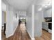 Hallway view showing hardwood floors, leading to the living area with a view and the nearby kitchen at 1901 Oyster Catcher Ln # 823, Clearwater, FL 33762
