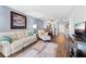 Bright living area with comfortable seating and hardwood floors leading to dining room at 1901 Oyster Catcher Ln # 823, Clearwater, FL 33762