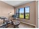 Cozy sitting area features a comfortable chair, ottoman, and large window with views of the golf course at 1901 Oyster Catcher Ln # 823, Clearwater, FL 33762