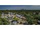 Aerial view of the neighborhood with treelined streets, a park, and city views in the distance at 2261 Queen S St, St Petersburg, FL 33712