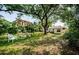 Lush backyard with mature trees and unique outdoor seating area at 2261 Queen S St, St Petersburg, FL 33712