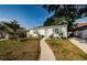 Charming single-story home with a well-manicured lawn, sidewalk, and a driveway with a minivan parked at 2261 Queen S St, St Petersburg, FL 33712