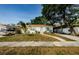 Charming single-story home with a well-manicured lawn, sidewalk, and a driveway with a minivan parked at 2261 Queen S St, St Petersburg, FL 33712