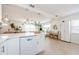 Bright, open floor plan featuring a kitchen with white cabinets, modern appliances, and an island with quartz countertops at 2261 Queen S St, St Petersburg, FL 33712