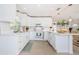 Bright kitchen with white cabinets, island seating, and stainless steel appliances at 2261 Queen S St, St Petersburg, FL 33712